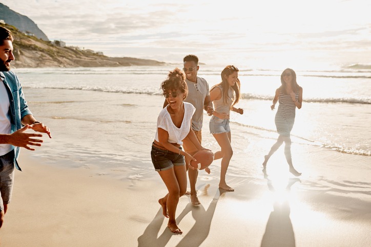 group on beach playing football